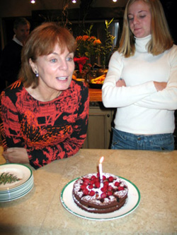 Mum endures our singing, while Lennie anxiously awaits a slice of cake to taste her creation.