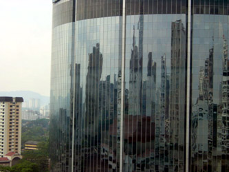 Reflection of high rise buildings in the mirrored surface of a high rise building.